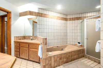 a bathroom with a tub and a sink at Stutzhaven In The Mountains Home in Estes Park
