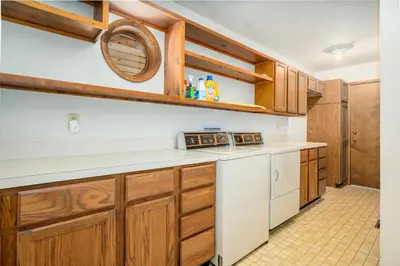 a kitchen with wooden cabinets and white appliances at Stutzhaven In The Mountains Home in Estes Park