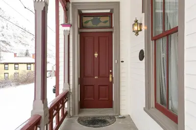a red door on a house with a porch at Rose Street Bed & Breakfast in Georgetown