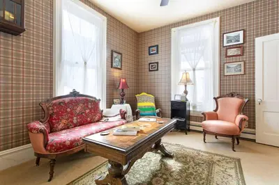 a living room with a couch and two chairs at Rose Street Bed & Breakfast in Georgetown