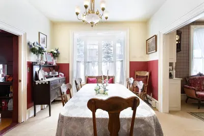 a dining room with a table and a chandelier at Rose Street Bed & Breakfast in Georgetown