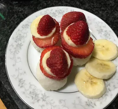 a plate of desserts with strawberries and bananas at Rose Street Bed & Breakfast in Georgetown