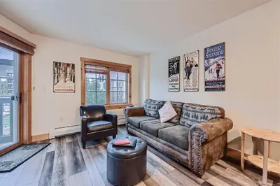 a living room with a couch and a table at 8619 Expedition Station Condo in Keystone