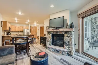 a living room with a fireplace with a tv on top at 8619 Expedition Station Condo in Keystone