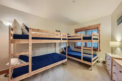 a bedroom with three bunk beds in a room at 8619 Expedition Station Condo in Keystone