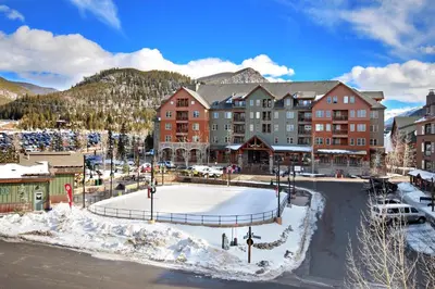 a resort in the mountains with snow on the ground at 8619 Expedition Station Condo in Keystone