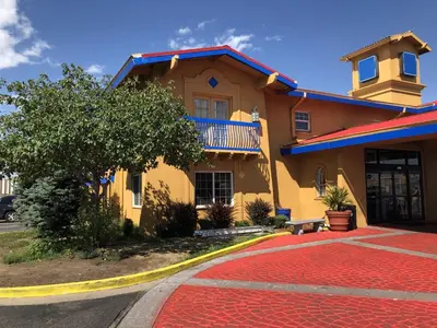 a yellow house with a red carpet in front of it at Americas Best Value Inn Denver in Denver