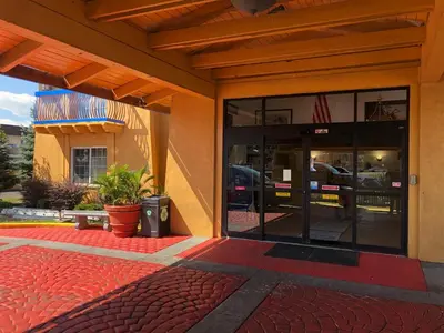 an outside view of a building with a parking garage at Americas Best Value Inn Denver in Denver