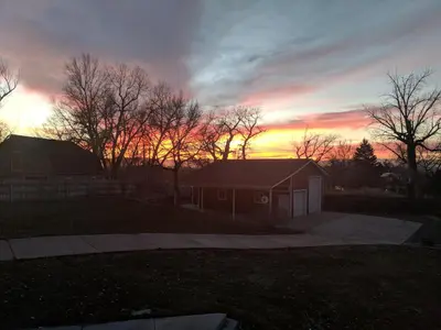 a house with a sunset in the background at DIA BnB - We love workers in Brighton