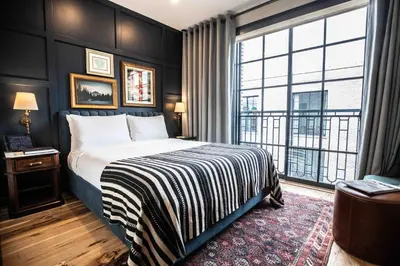 a hotel room with a bed and a large window at The Ramble Hotel in Denver