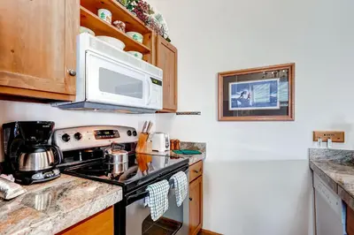 a kitchen with a stove and a microwave at Jackpine 8021 in Keystone