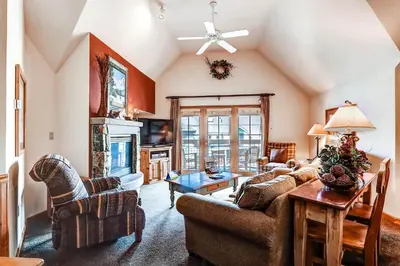 a living room with two couches and a table at Jackpine 8021 in Keystone
