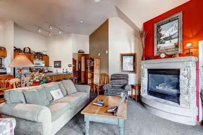 a living room with a couch and a fireplace at Jackpine 8021 in Keystone