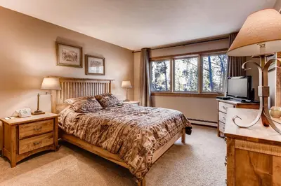 a bedroom with a bed and a tv and a window at Quicksilver 1662 in Keystone