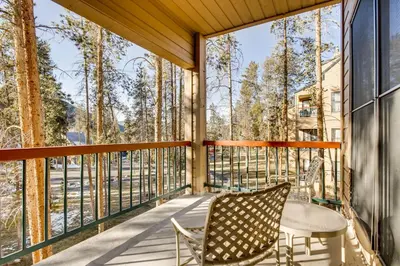 a screened porch with two chairs and a table on it at Quicksilver 1662 in Keystone