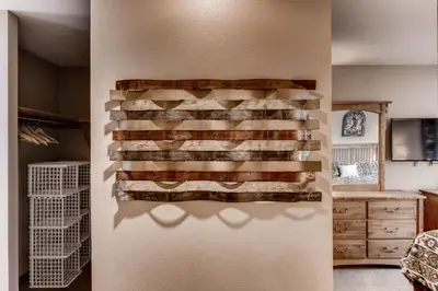 a wall with a bunch of reclaimed wood on it at Quicksilver 1662 in Keystone