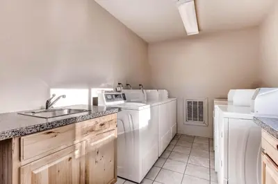 a kitchen with a washer and dryer and a sink at Quicksilver 1662 in Keystone