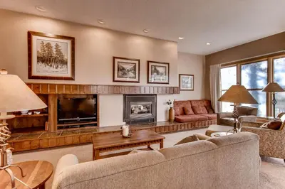 a living room with a couch and a fireplace at Quicksilver 1662 in Keystone