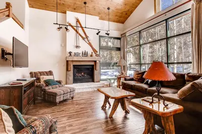 a living room with a couch and a fireplace at Ski Tip Townhomes 8713 in Keystone
