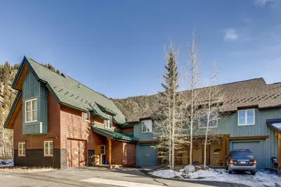 a house with a car parked in front of it at Ski Tip Townhomes 8713 in Keystone