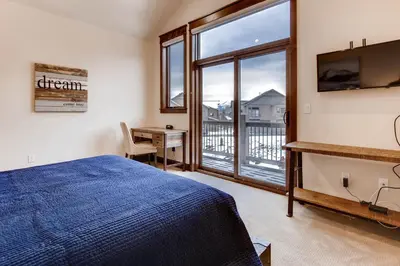 a bedroom with a bed and a desk and a window at River Run Townhome RR38 in Keystone