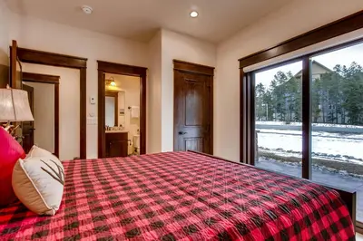 a bedroom with a large bed and a window at River Run Townhome RR38 in Keystone