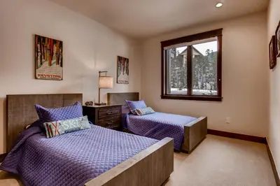 a bedroom with two beds and a window at River Run Townhome RR38 in Keystone