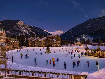 a group of people skating on a rink in the snow at River Run Townhome RR38 in Keystone