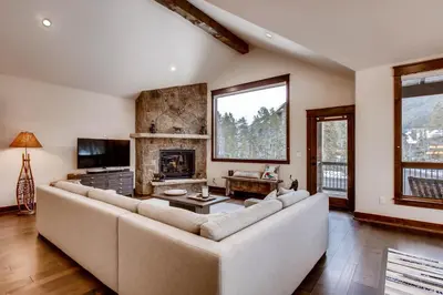 a living room with a large couch and a fireplace at River Run Townhome RR38 in Keystone
