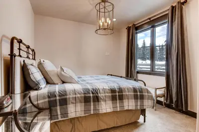 a bedroom with a bed and a window at River Run Townhome RR42 in Keystone