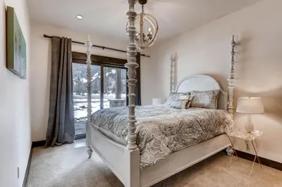 a bedroom with a canopy bed and a window at River Run Townhome RR42 in Keystone