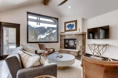 a living room with a couch and a fireplace at River Run Townhome RR42 in Keystone