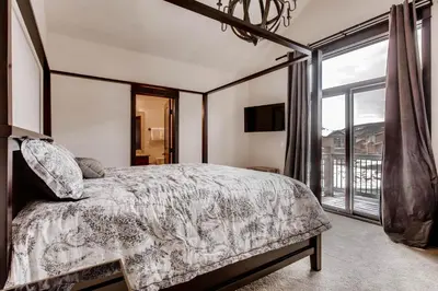a bedroom with a bed and a large window at River Run Townhome RR42 in Keystone