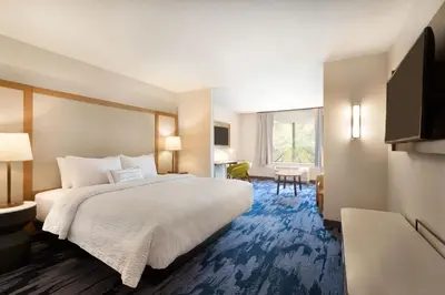 a hotel room with a bed and a desk at Fairfield Inn & Suites by Marriott Boulder Longmont in Longmont