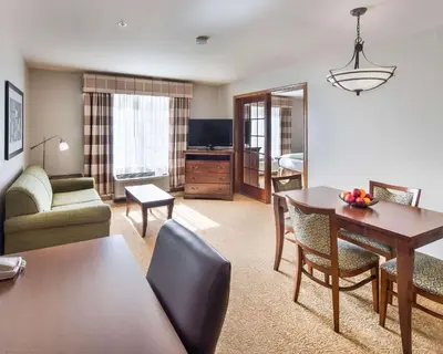 a living room with a couch and a table at Country Inn & Suites by Radisson, Greeley, CO in Greeley