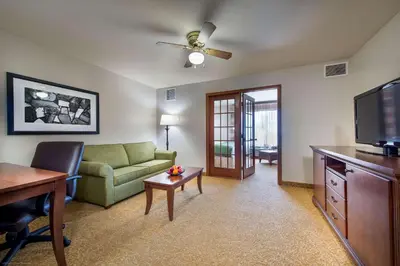 a living room with a couch and a tv at Country Inn & Suites by Radisson, Greeley, CO in Greeley