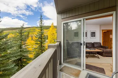 a balcony of a house with a view of the mountains at 8577 Expedition Station Condo in Keystone