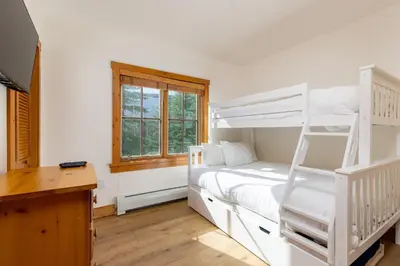 a bedroom with a bunk bed and a desk at 8577 Expedition Station Condo in Keystone