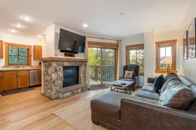 a living room with a couch and a fireplace at 8577 Expedition Station Condo in Keystone