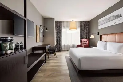 a hotel room with a bed and a desk at Origin Red Rocks, a Wyndham Hotel in Golden