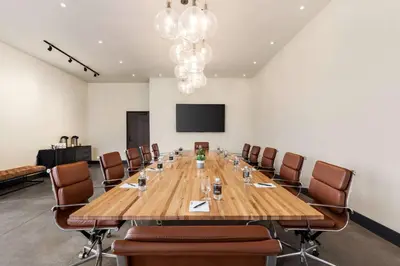 a conference room with a large wooden table and chairs at Origin Red Rocks, a Wyndham Hotel in Golden