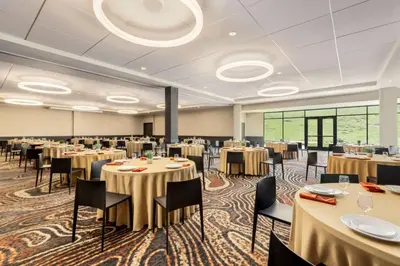 a large banquet room with tables and chairs at Origin Red Rocks, a Wyndham Hotel in Golden