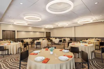 a conference room with white tables and chairs at Origin Red Rocks, a Wyndham Hotel in Golden