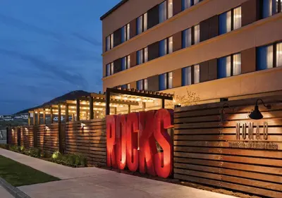 a building with red graffiti on the side of it at Origin Red Rocks, a Wyndham Hotel in Golden