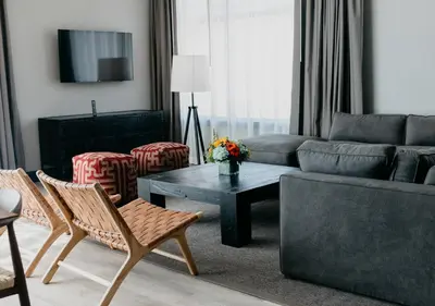 a living room with a couch and a table at Origin Red Rocks, a Wyndham Hotel in Golden