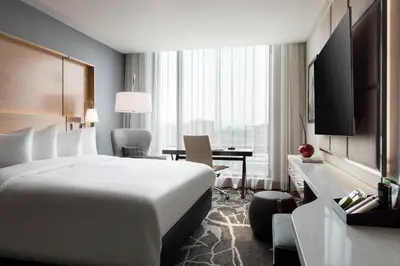 a hotel room with a large bed and a desk at The Jacquard, Autograph Collection in Denver