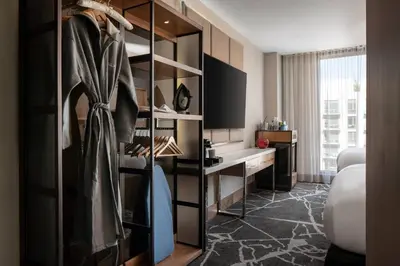 a room with a closet with a desk at The Jacquard, Autograph Collection in Denver