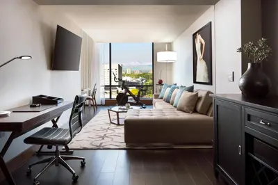 a living room with a couch and a desk at The Jacquard, Autograph Collection in Denver