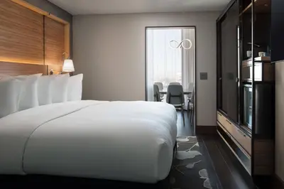 a large white bed in a hotel room at The Jacquard, Autograph Collection in Denver