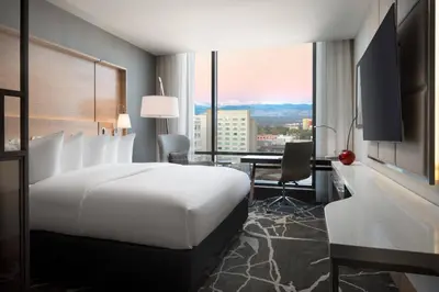 a hotel room with a bed and a desk and a window at The Jacquard, Autograph Collection in Denver